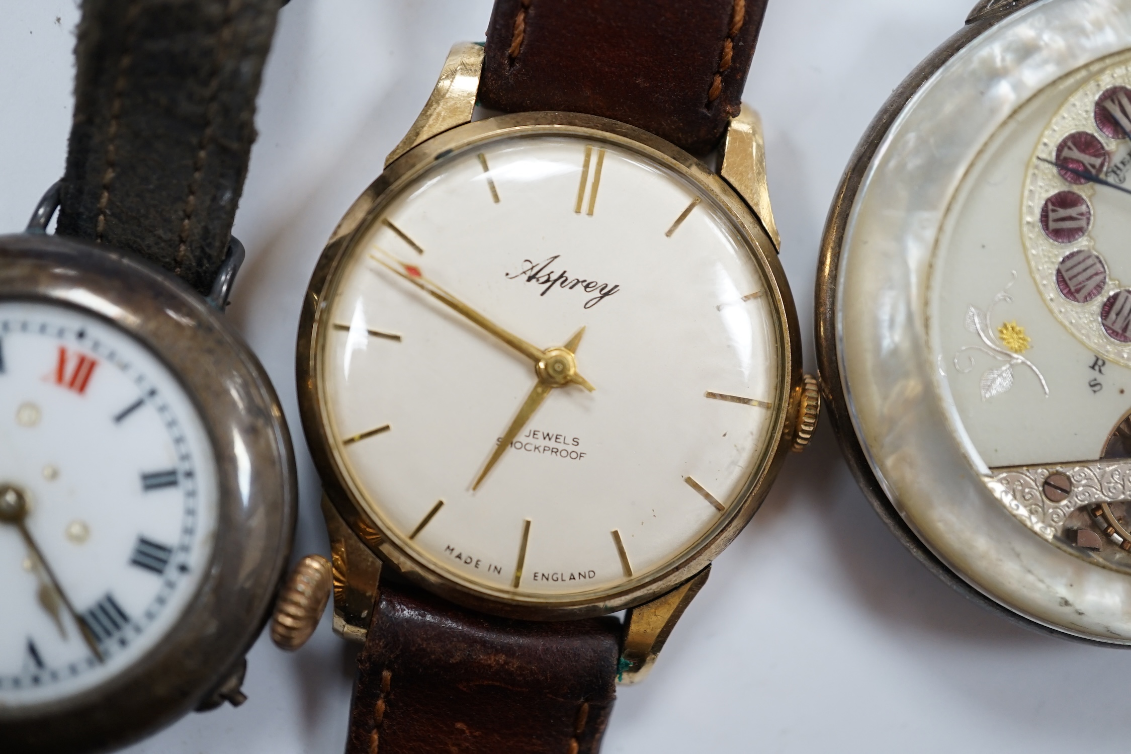 A gentleman's 9ct gold manual wind wrist watch, retailed by Asprey, together with a silver wrist watch and a mother of pearl cased Hebdomas pocket watch. Condition - poor to fair
